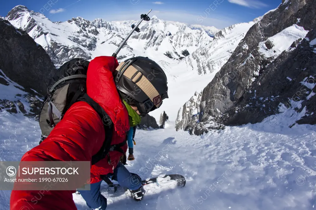A male splitboarder captures a self portait pov while descending a steep couloir on Mt French, Peter Lougheed Provincial Park, Kananaskis, AB
