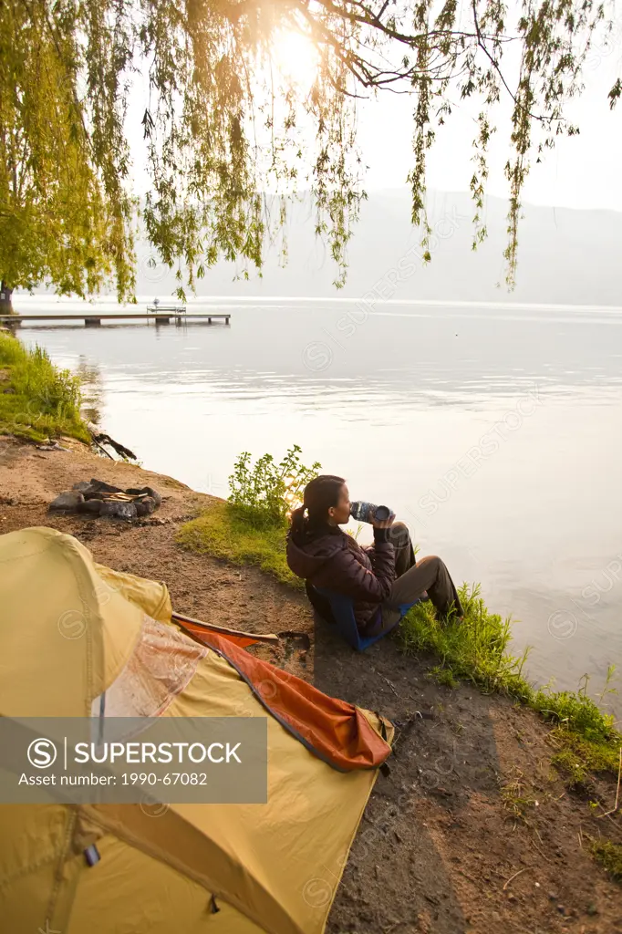 A young woman camping by Skaha Lake, Penticton, BC