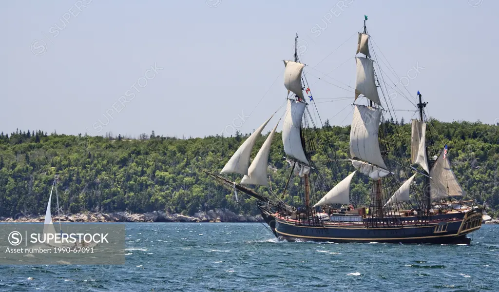 Sailing ship Bounty departs Halifax Harbour as a sailboat races alongside during the Parade of Sail conclusion of the 2012 Tall Ships festival in Hali...