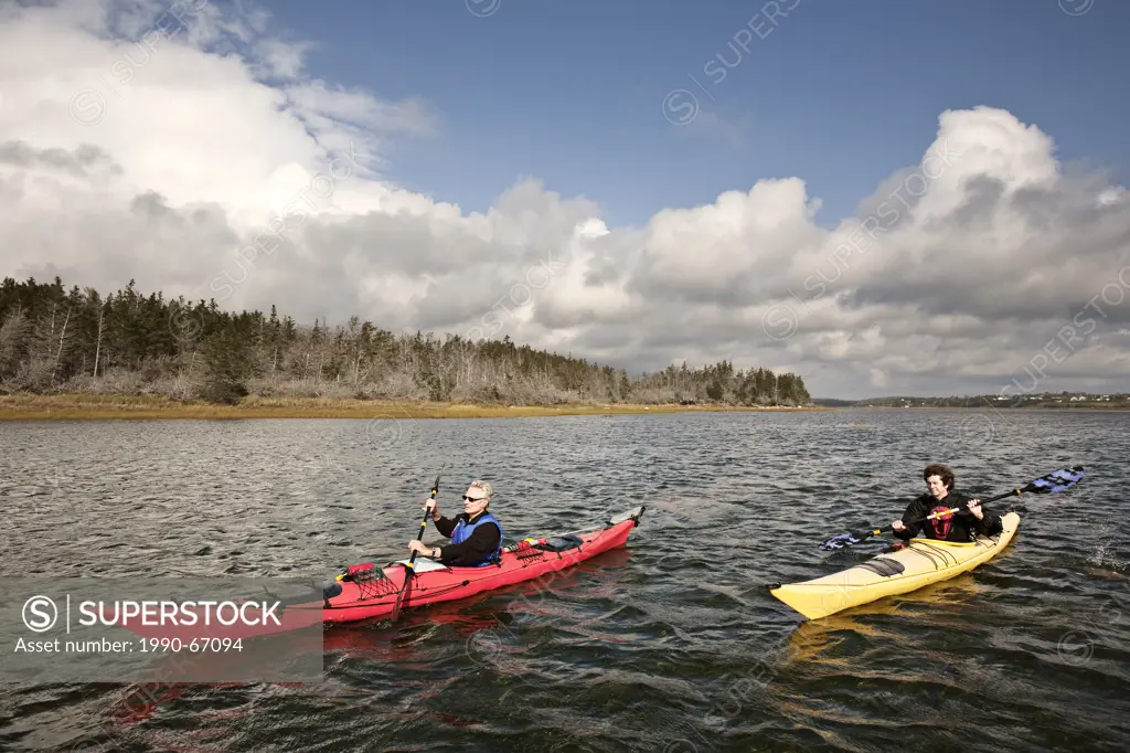 Sea kayakers in Nova Scotia paddle through Chezzetcook Inlet. Accomplished Nova Scotian author, professor, and surfer Lesley Choyce right spends a day...