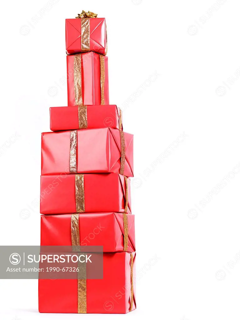 Pile of red gift boxes Christmas presents stacked in a shape of an alcoholic beverage bottle isolated on white background.