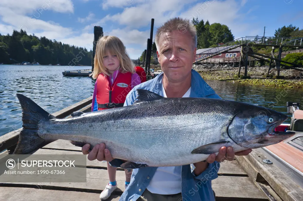 Proud fisherman with 24 pound chinook salmon and unimpressed daughter.