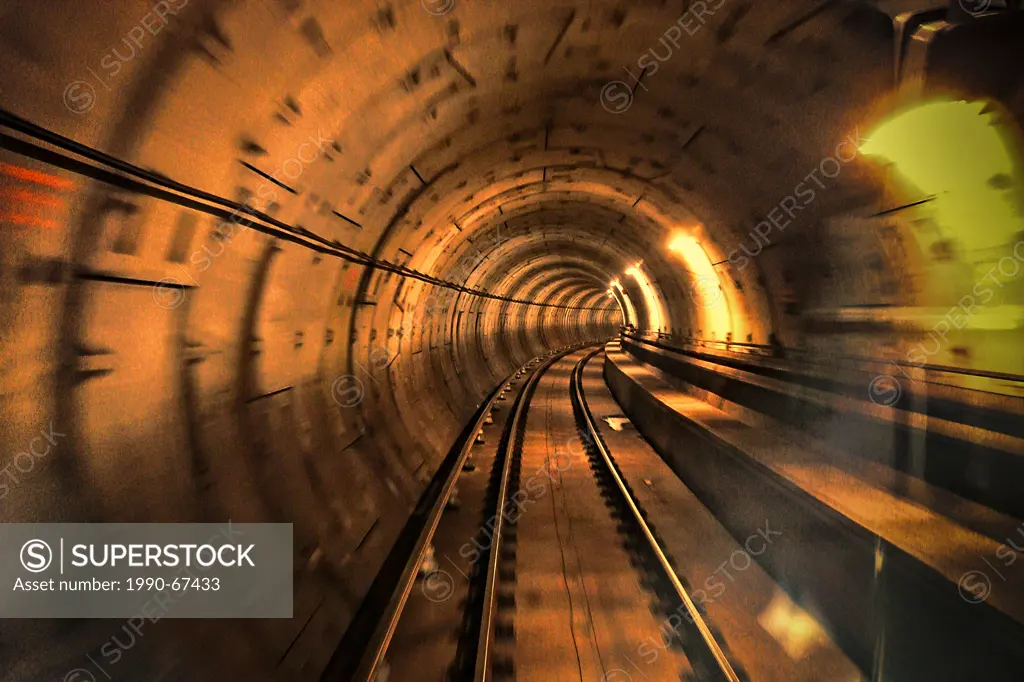 on the train going shooting behind the travelling train__Vancouver BC skytrain tunnel