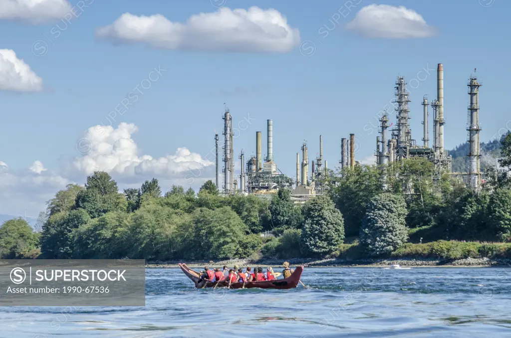 Salish Canoe passes Chevron Refinery, Burrard Inlet, during Many People, One Canoe. Salish First Nations, Gathering of Canoes to Protect the Salish Se...