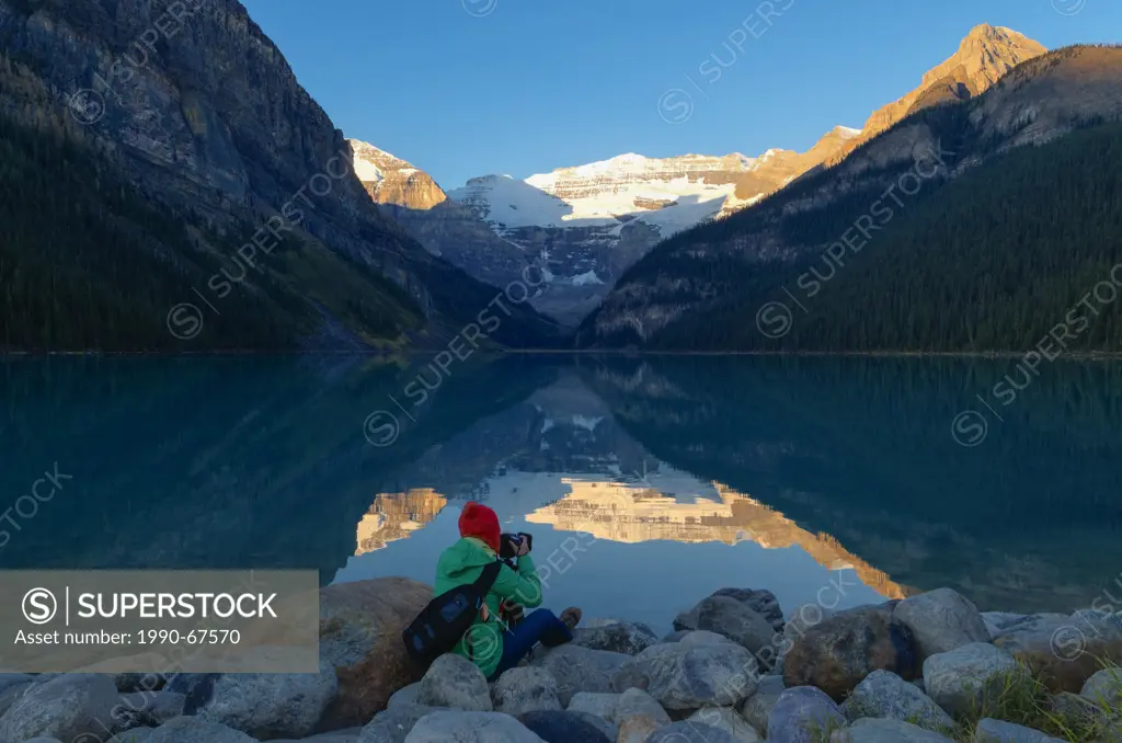 Young Asian female photographing , Lake Louise, Banff National Park, Alberta, Canada