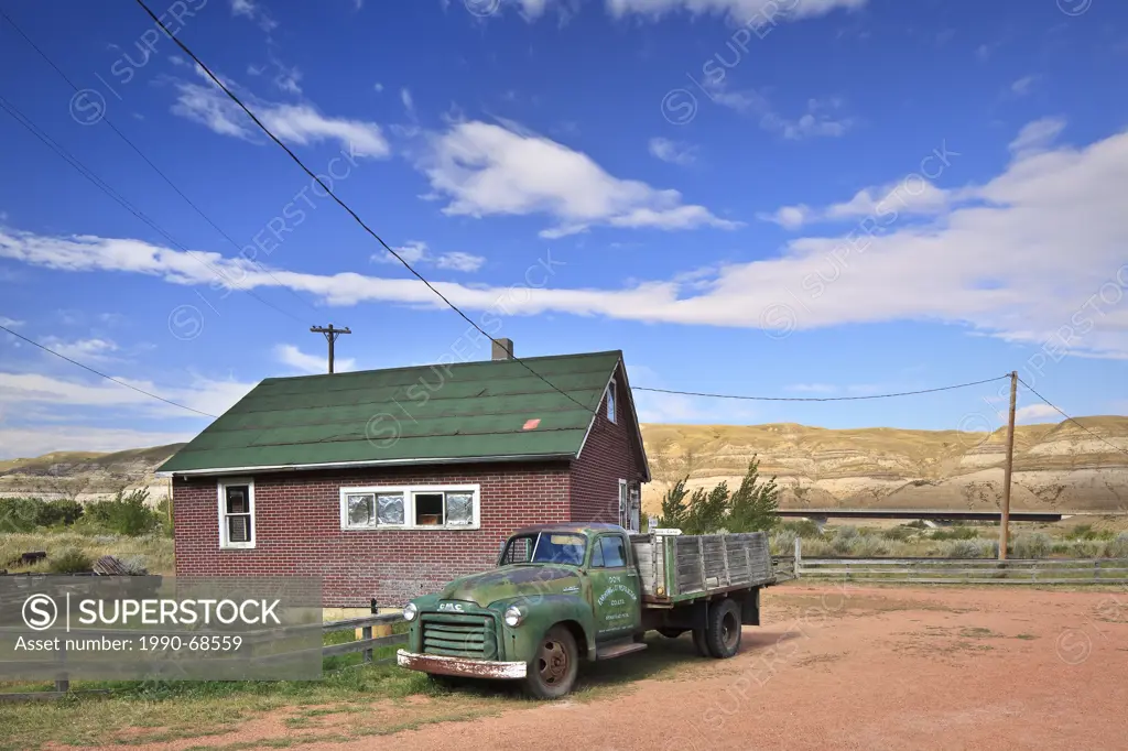 Old farm truck and home, Atlas Coal Mine National Historic Site, East Coulee, Alberta, Canada