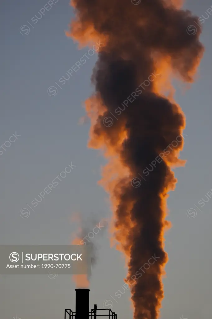 Smoke and steam billow out of smokestacks at a pulp and paper mill Powell River, British Columbia, Canada