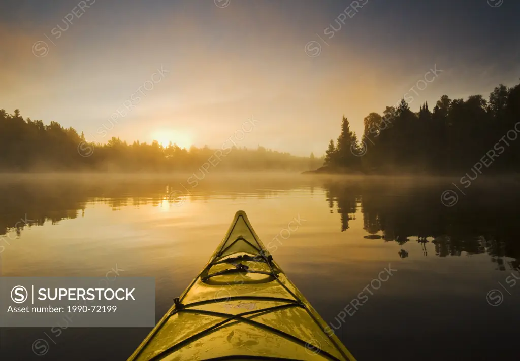 Kayaking during a mistly morning on Lake of the Woods, Northwestern Ontario, Canada