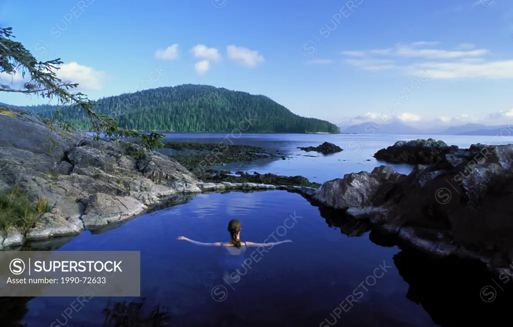 Woman in natural hotspring pool, Gwaii Haanas National Park, Queen Charlotte Islands, British Columbia, Canada