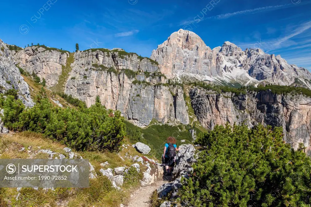 A female hiker on a trail in the Dolomite mountains in northern Italy.