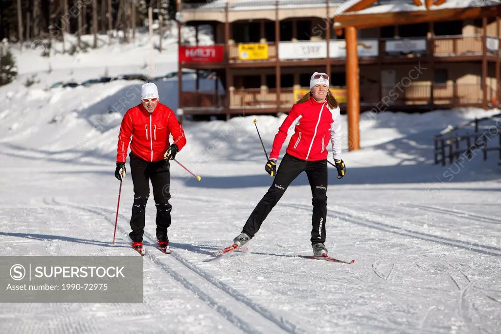 Female and Male young adult Cross Country Skiing at Sovereign Lake Nordic Centre, near Vernon, Okanagan, British Columbia, Canada