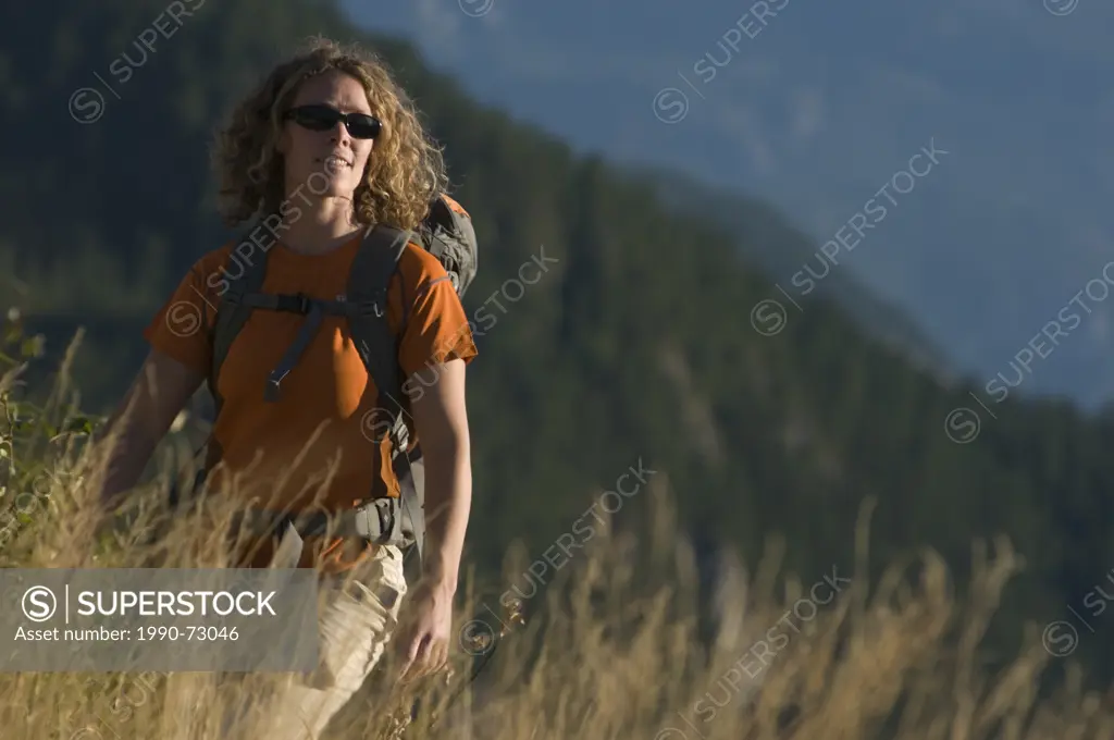 Woman hiking below the Tantalus Range, Squamish, British Columbia, Canada