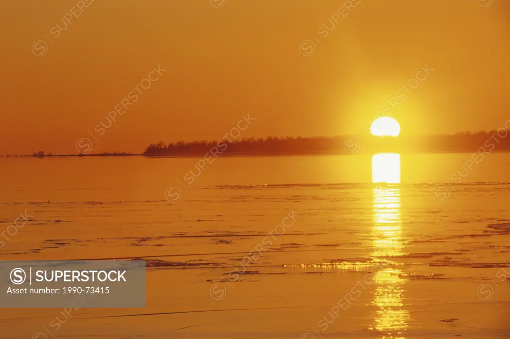 Sunset over ice on Lake Superior at Katherine Cove, Lake Superior Provincial Park, Ontario, Canada