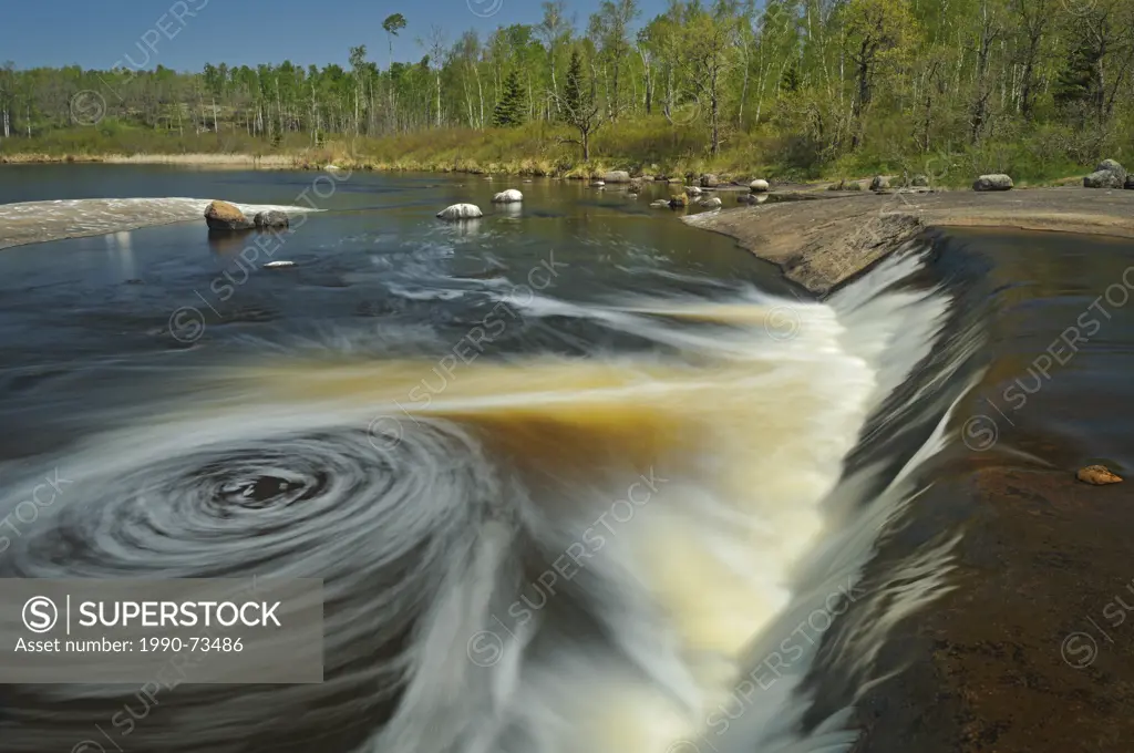 Swirling waters of the Whiteshell River as they flow into White Lake at Rainbow Falls, Whiteshell Provincial Park, Manitoba, Canada