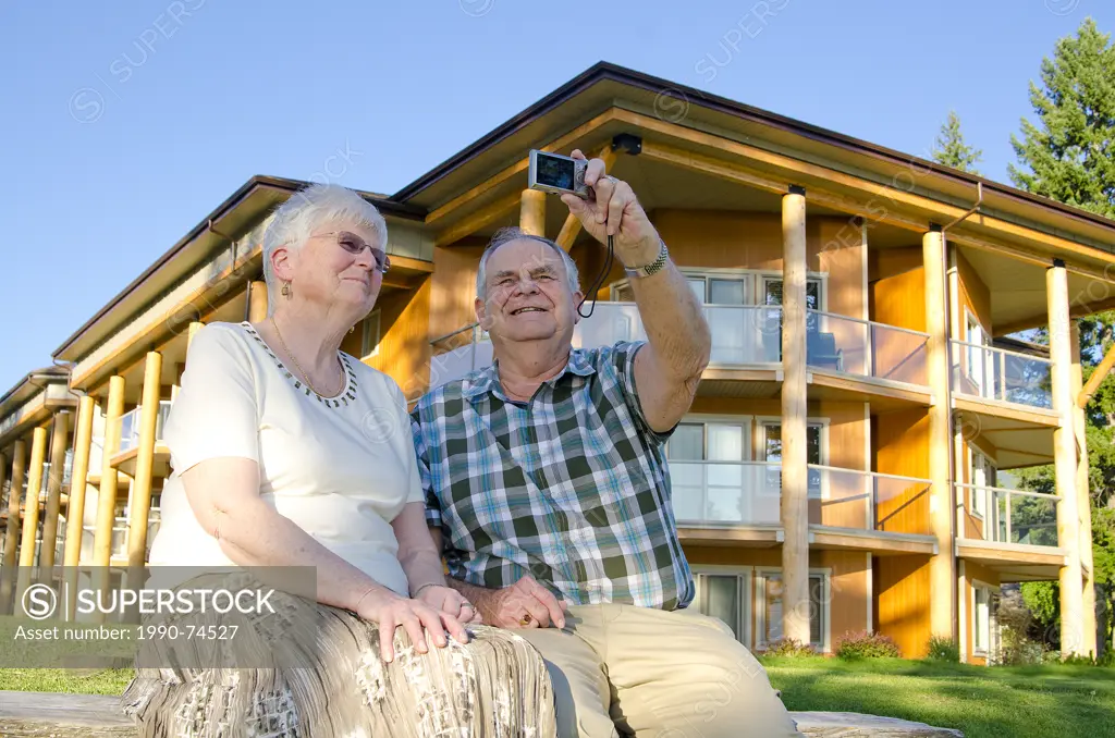 Couple takes a self-portrait on the shores of Little Shuswap Lake at Quaaout Lodge in the Shuswap region of British Columbia, Canada.