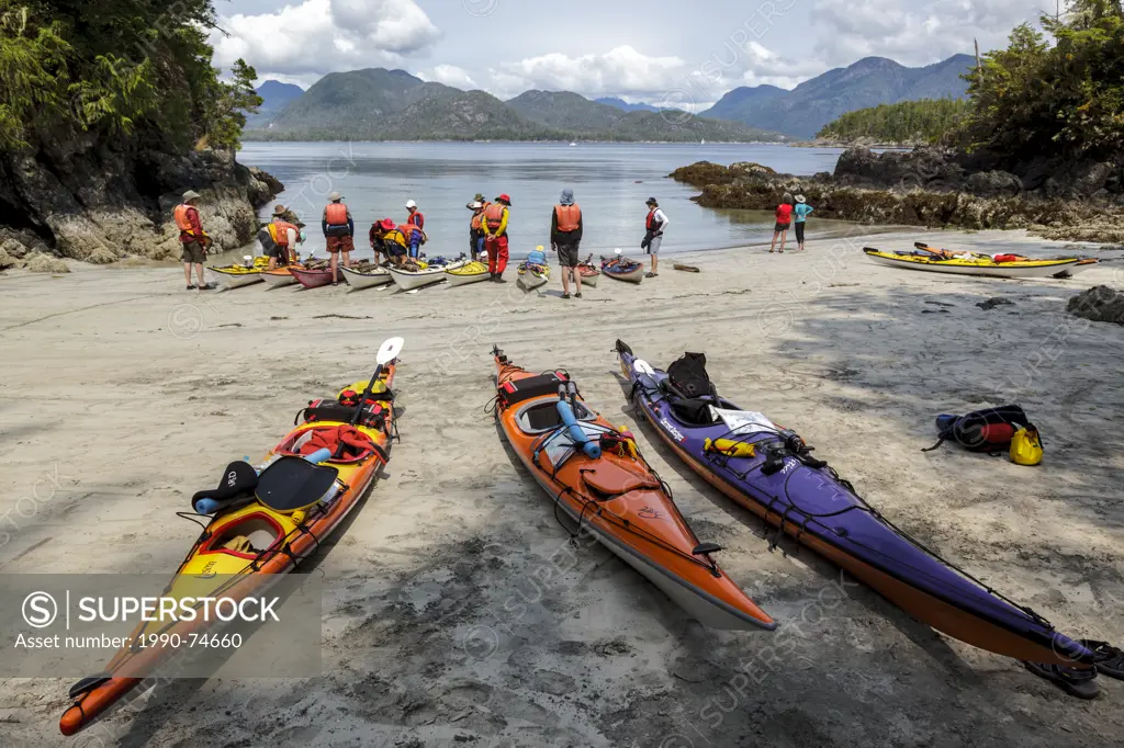 A guided kayak group prepare to depart from Rosa Island in Nuchatlitz Provincial Park on British Columbia's west coast, Canada. No Model Release