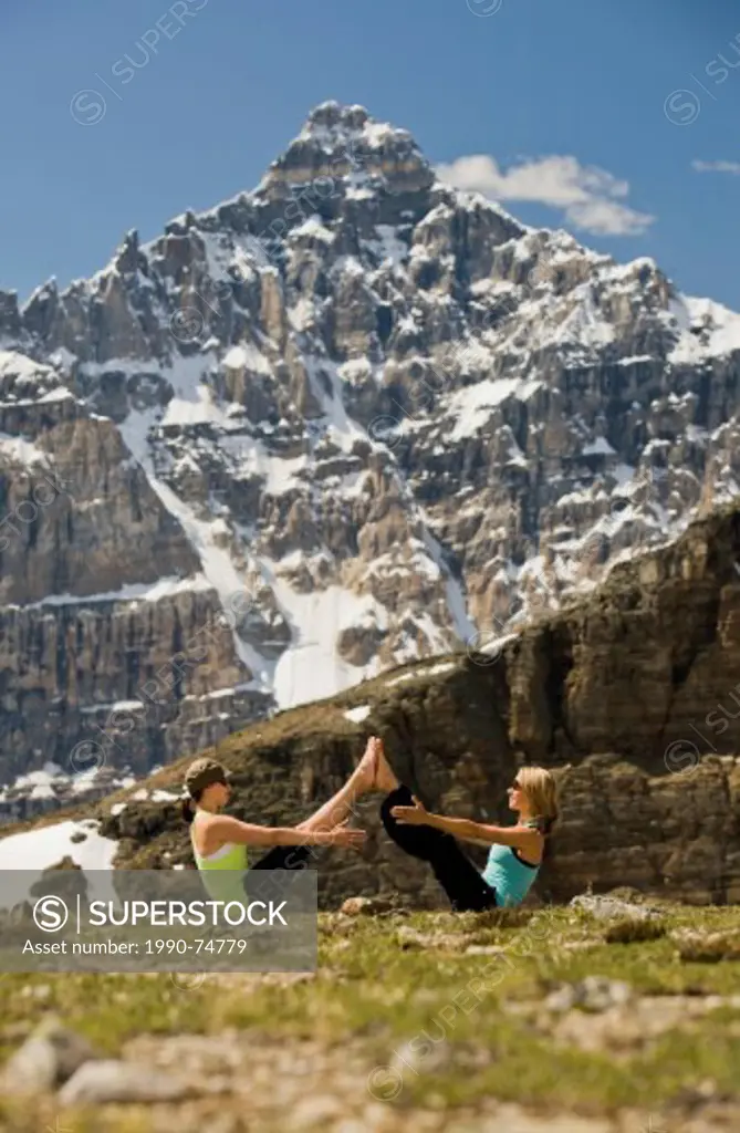 Women in Boat Pose, Paripurna Navasana, Valley of the Ten Peaks, Banff National Park, Alberta, Canada.