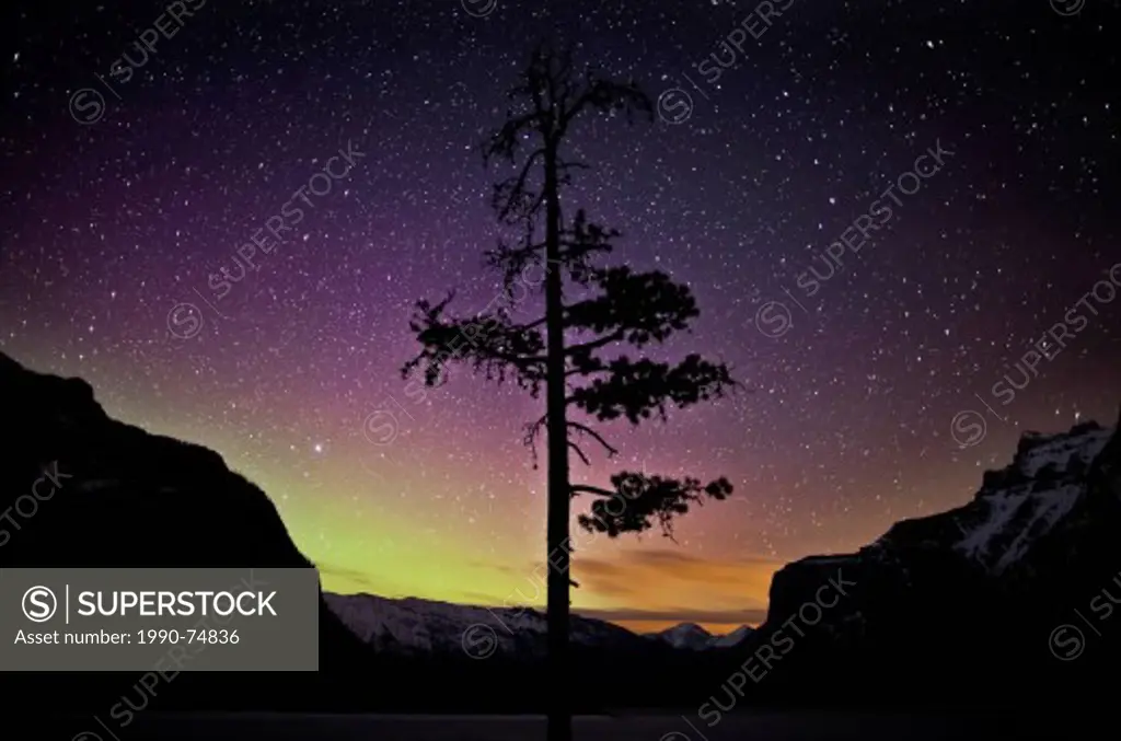 Stars and aurora borealis at Lake Minnewanka, Banff National Park.