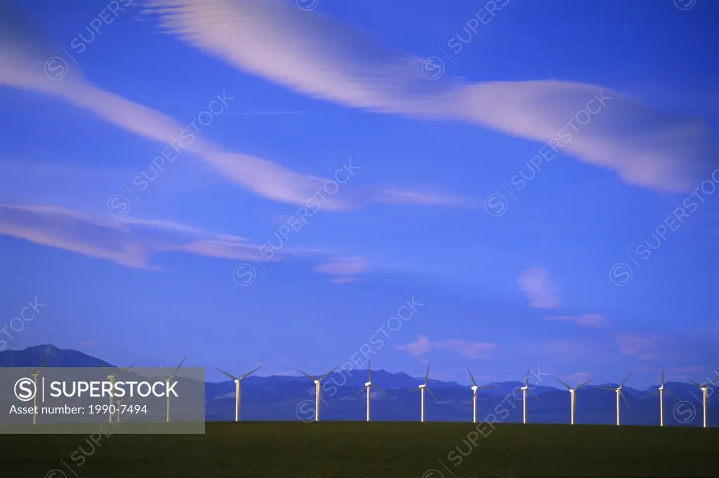 clouds, wind turbines and Rocky Mountains, Pincher Creek, Alberta, Canada