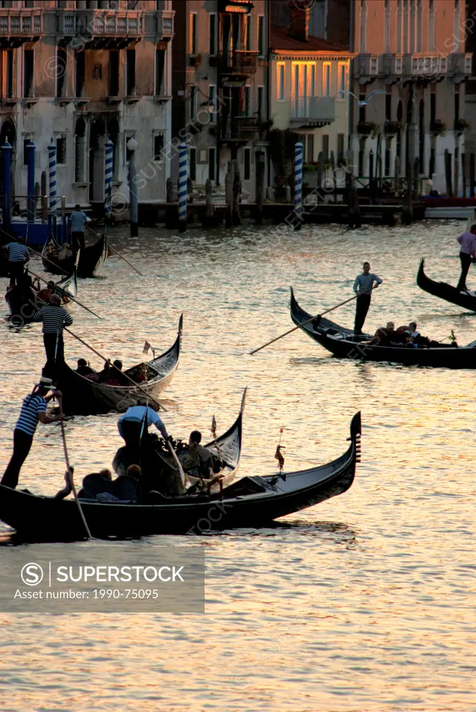 Gondolas carrying tourists on Grand Canal in Venice, Italy