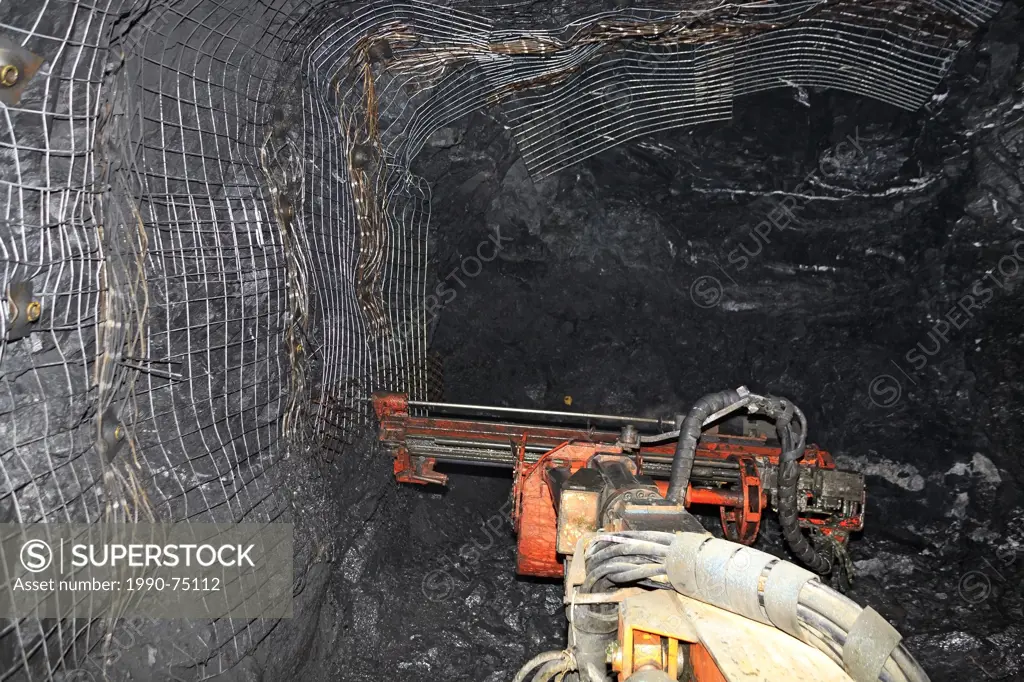 Underground mining drill rig called a 'Jumbo' working at rock face, Eskay Creek mine, Iskut, British Columbia