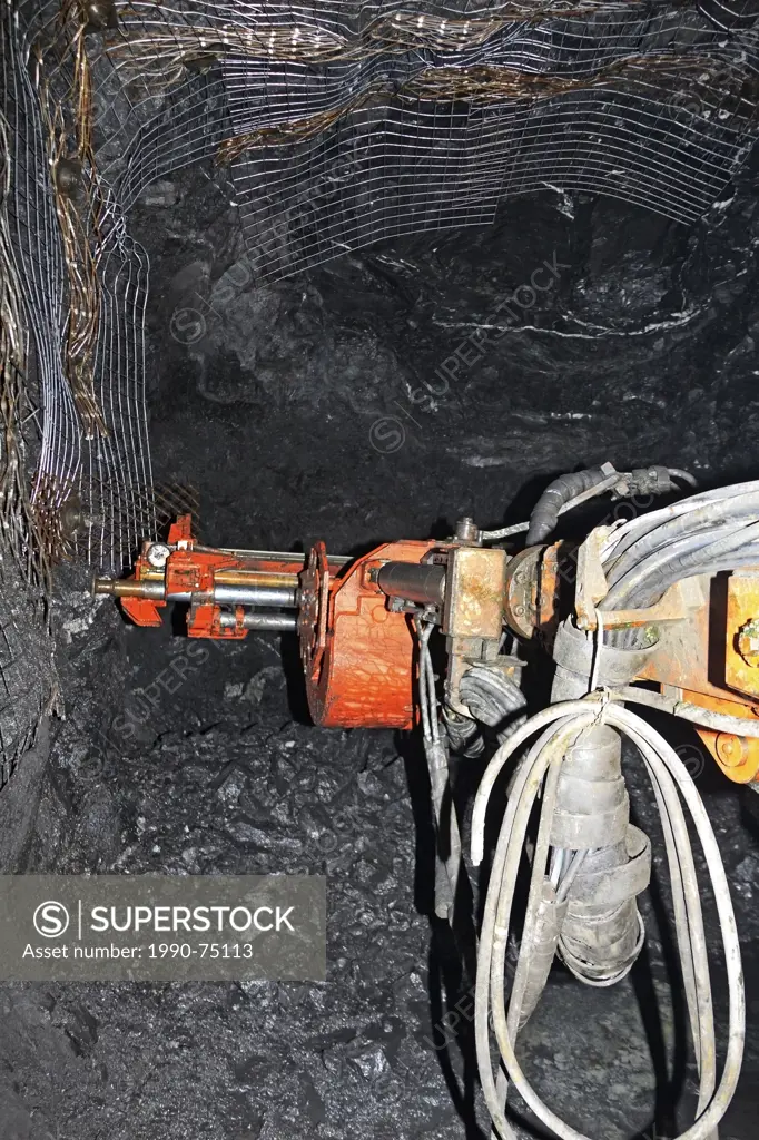 Underground mining drill rig called a 'Jumbo' working at rock face, Eskay Creek mine, Iskut, British Columbia