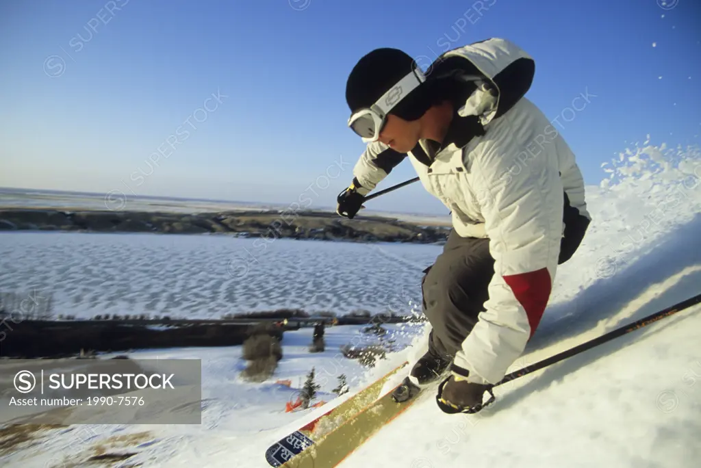Young man skiing corn snow at Blackstrap Resort, Saskatchewan, Canada
