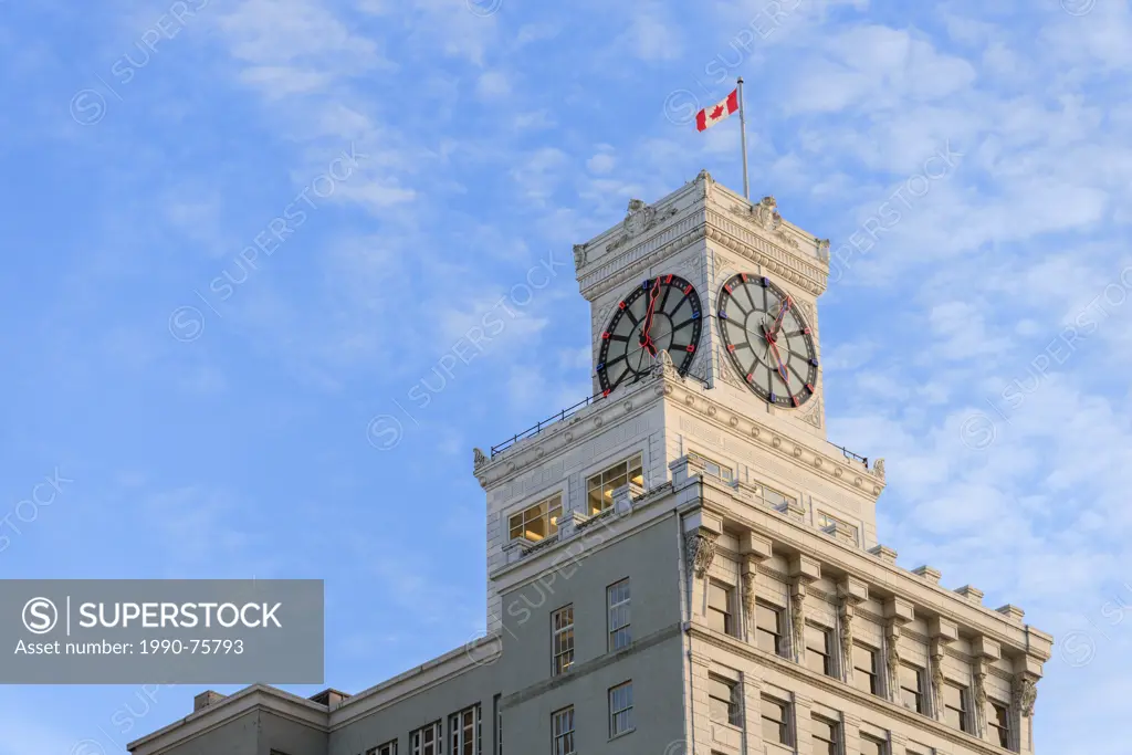 The Vancouver Block, a 100 year old heritage building with a giant neon clock on the roof at 736 Granville st, Vancouver, British Columbia, Canada