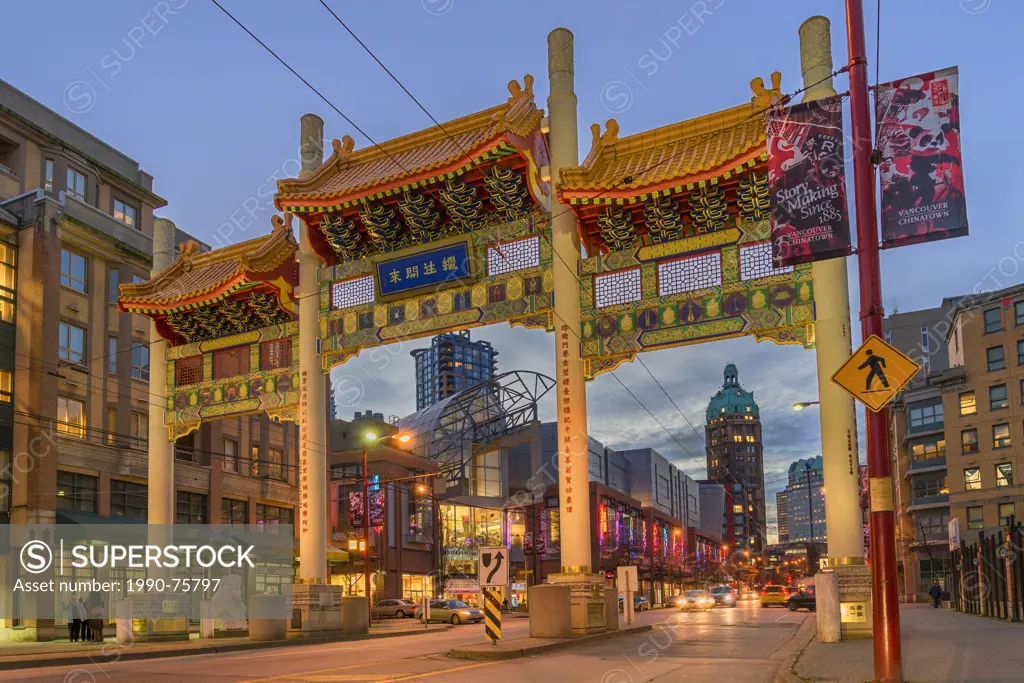 The Millenium Chinatown Gate with the Sun Tower in the distance, West Pender Street, Vancouver, British Columbia, Canada