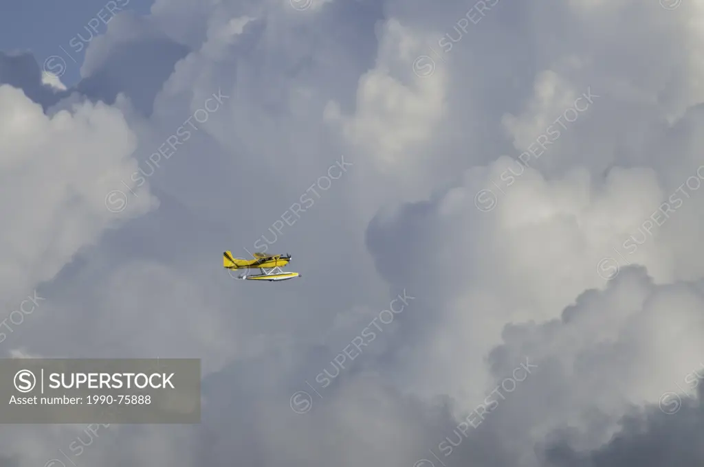 Float plane flying in the clouds.
