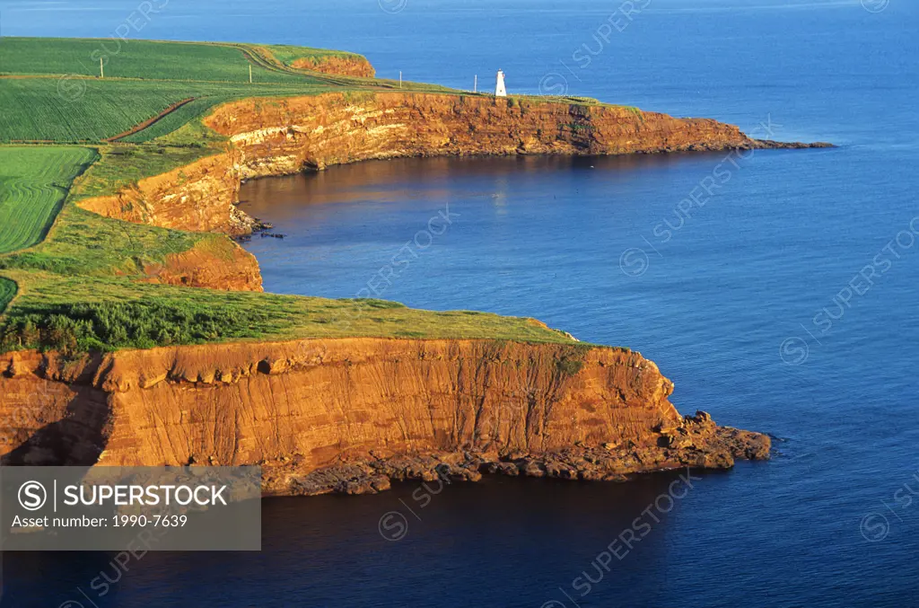 Aerial of sandstone cliffs and lighthouse at Cape Tryon, Prince Edward Island, Canada