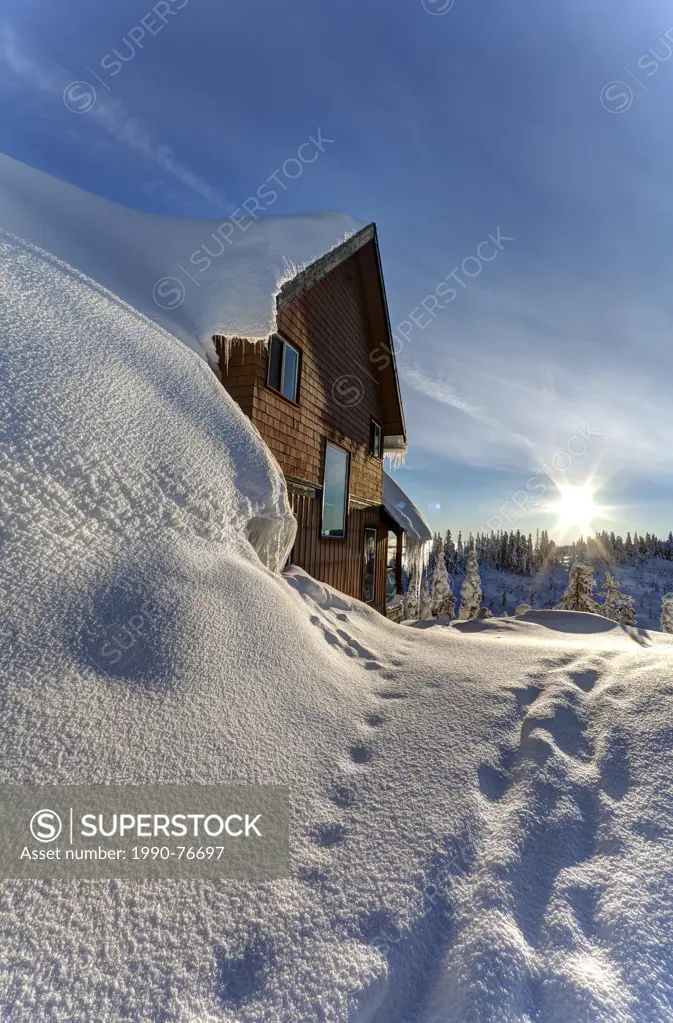 A ski chalet blanketed in deep snow is a familiar site up at Mt. Washington's small village loacted near the ski hill. Mt. Washington, The Comox Valle...