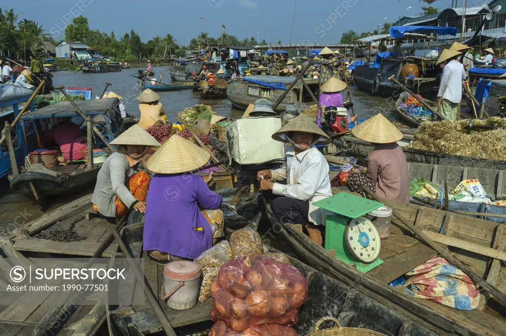A group of vendors sell their produce at the floating market in the Mekong Delta region of Southern Vietnam, Socialist Republic of Vietnam. No Model R...