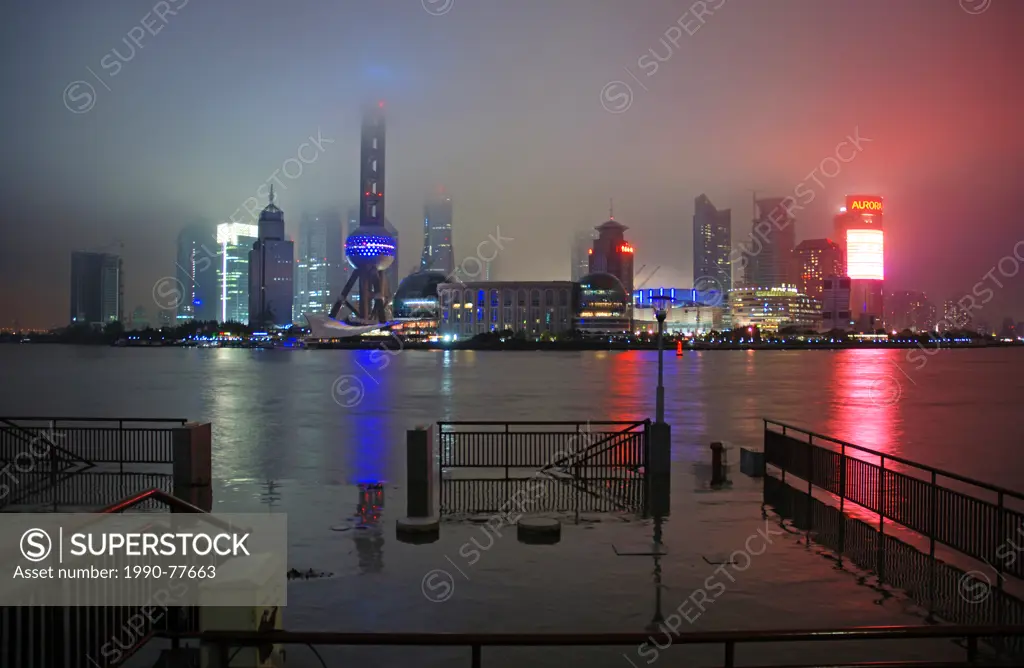 Oriental Pearl TV tower and Pudong skyline at rainy night, Shanghai, China