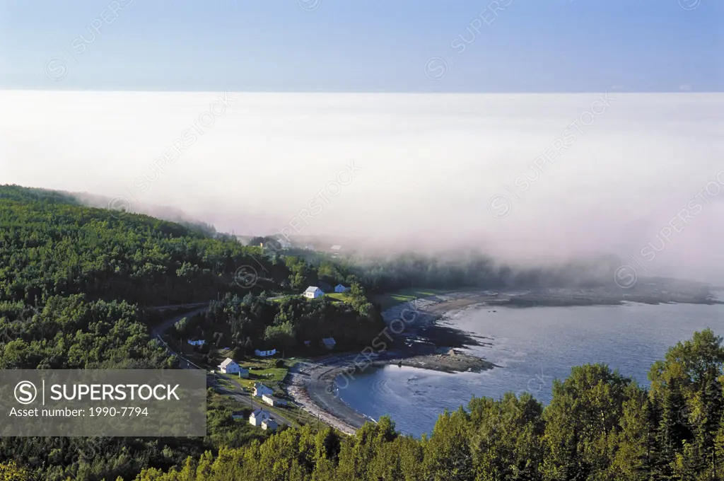 Fog bank rolls in along the rugged north shore of the Gaspé Peninsula on the Gulf of St  Lawrence near Rivière-la-Madeleine, Quebec, Canada