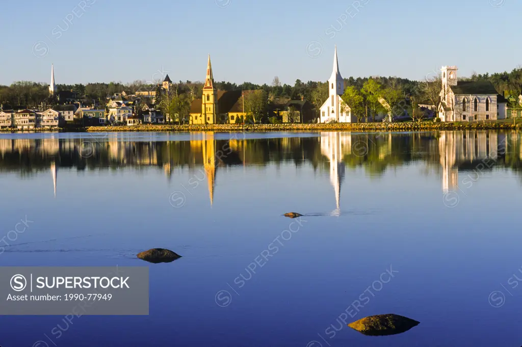 Churches reflected in waterfront at sunrise, Mahone Bay, Nova Scotia, Canada