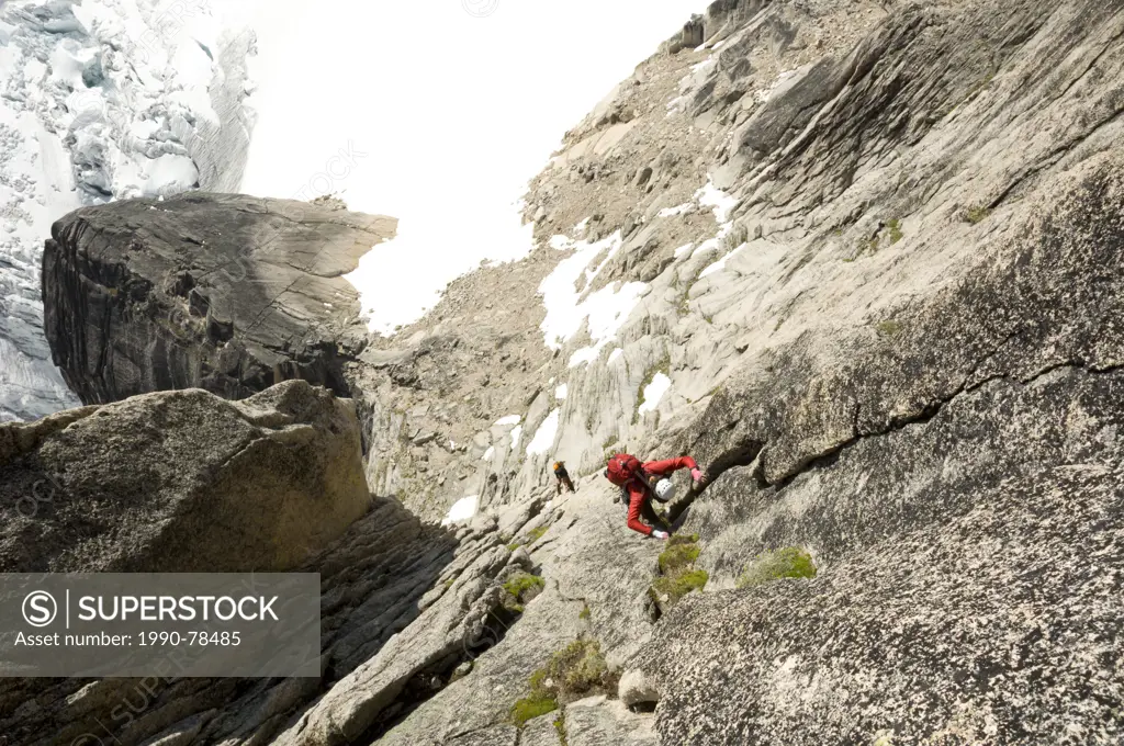 Two climbers ascent Surf's Up, a rock-climbing route on Snowpatch Spire, Bugaboos, British Columbia