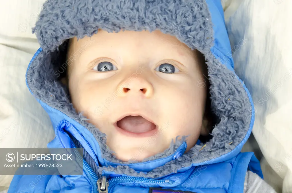 A six-month-old baby all bundled up for going outside