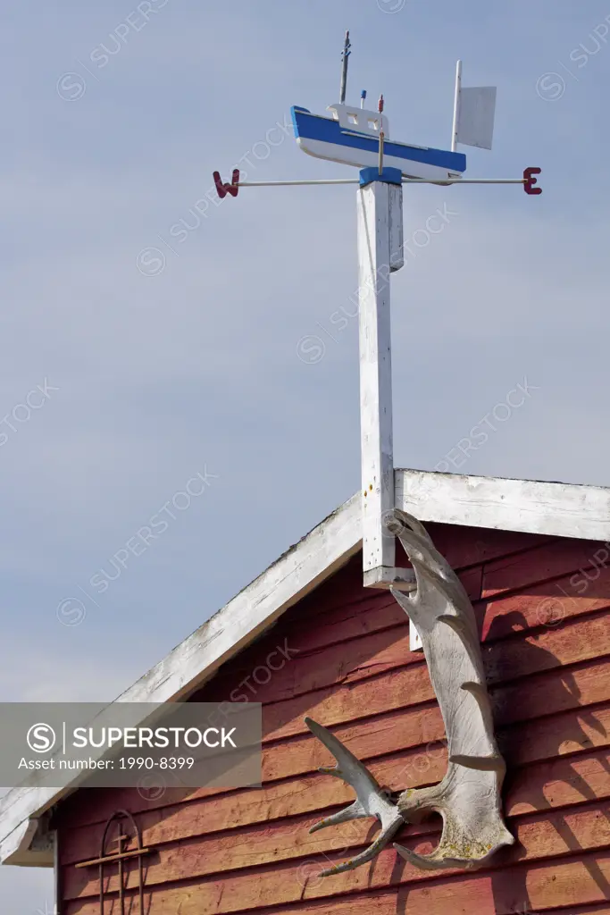Weathervane atop a fishing stage in Conche Harbour, Conche, French Shore, Great Northern Peninsula, Viking Trail, Newfoundland & Labrador, Canada