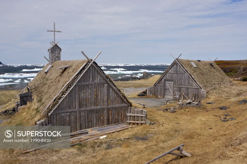 Re-created huts and buildings at the Norstead Viking Site a Viking Port of Trade backdropped by pack ice in the harbour, Viking Trail, Great Northern ...