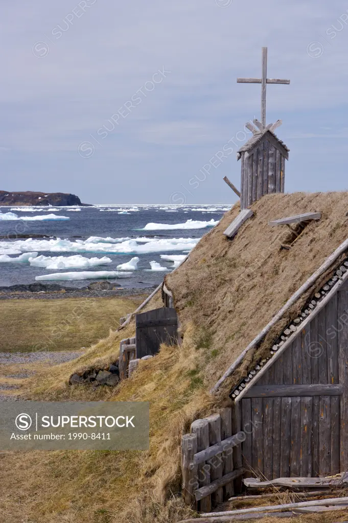 Re-created huts and buildings at the Norstead Viking Site a Viking Port of Trade backdropped by pack ice in the harbour, Viking Trail, Great Northern ...