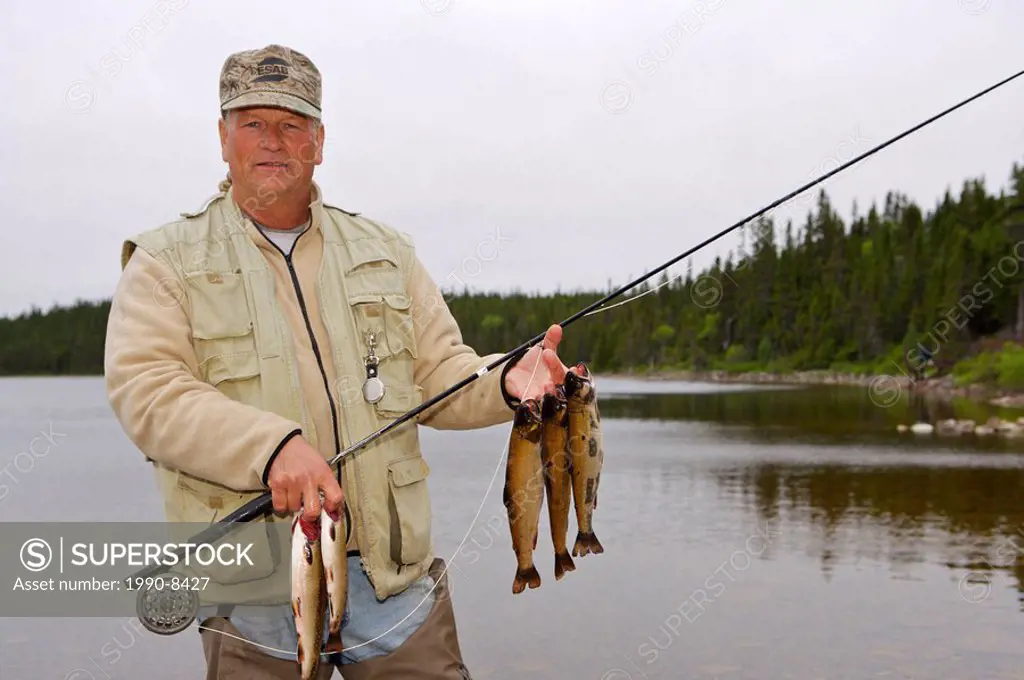 Fisherman with a catch of Speckled Trout, caught near Tuckamore Lodge, Main Brook, Viking Trail, Great Northern Peninsula, Newfoundland & Labrador, Ca...