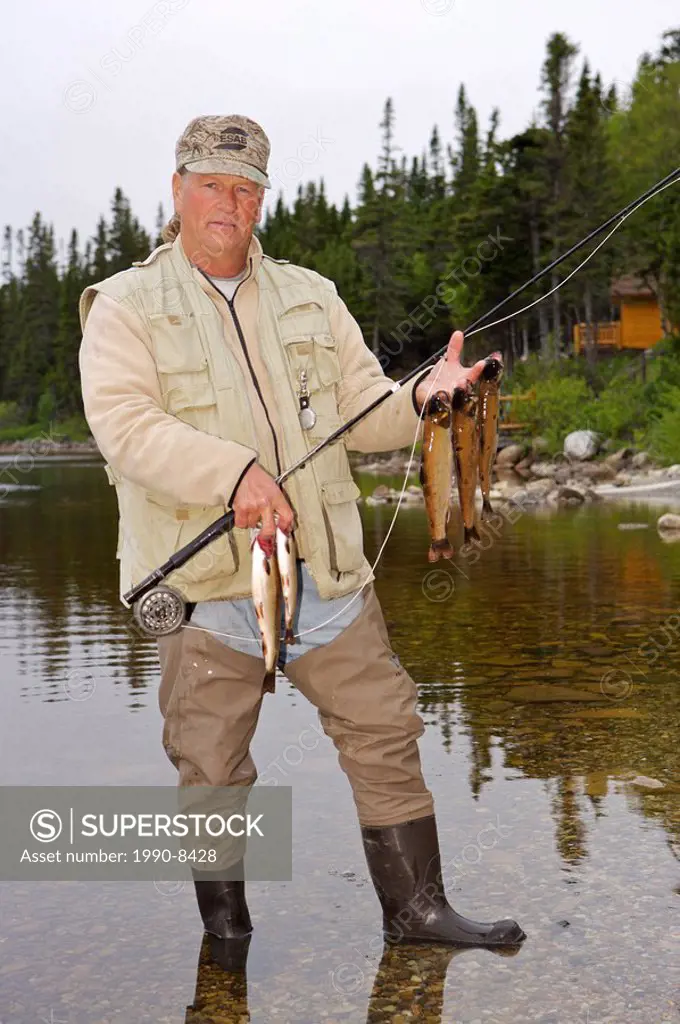 Fisherman with a catch of Speckled Trout, caught near Tuckamore Lodge, Main Brook, Viking Trail, Great Northern Peninsula, Newfoundland & Labrador, Ca...