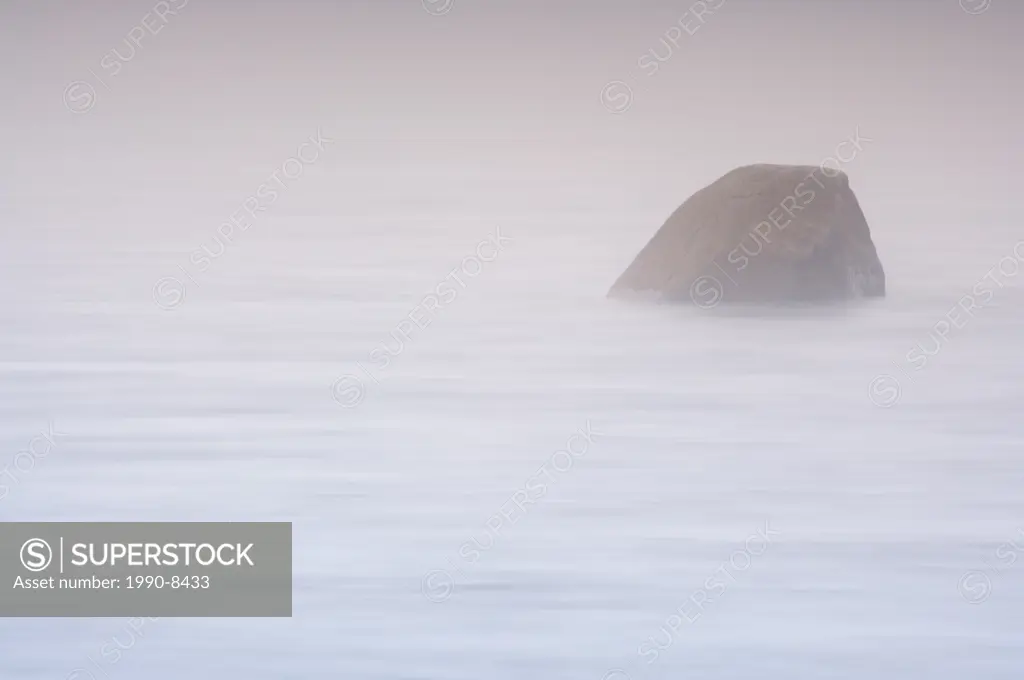 Boulder in the Pinware River mouth shrouded in fog at the Pinware River Provincial Park along the Labrador Coastal Drive, Viking Trail, Strait of Bell...