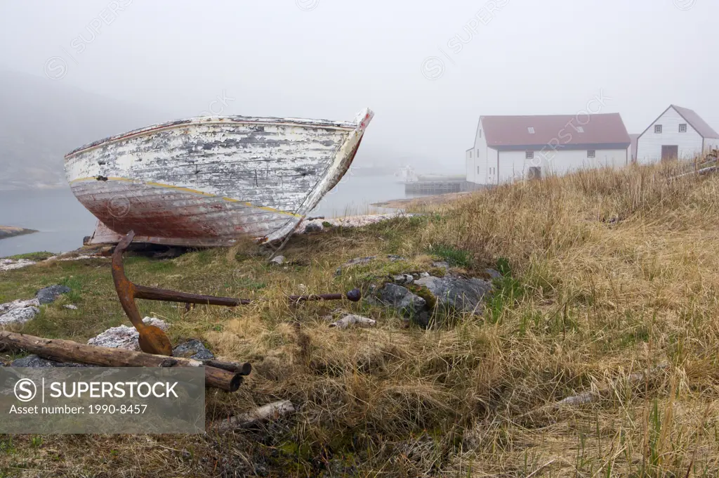 An old fishing boat hauled out on the shore at Battle Harbour, Battle Island at the entrance to the St Lewis Inlet, Viking Trail, Southern Labrador, N...