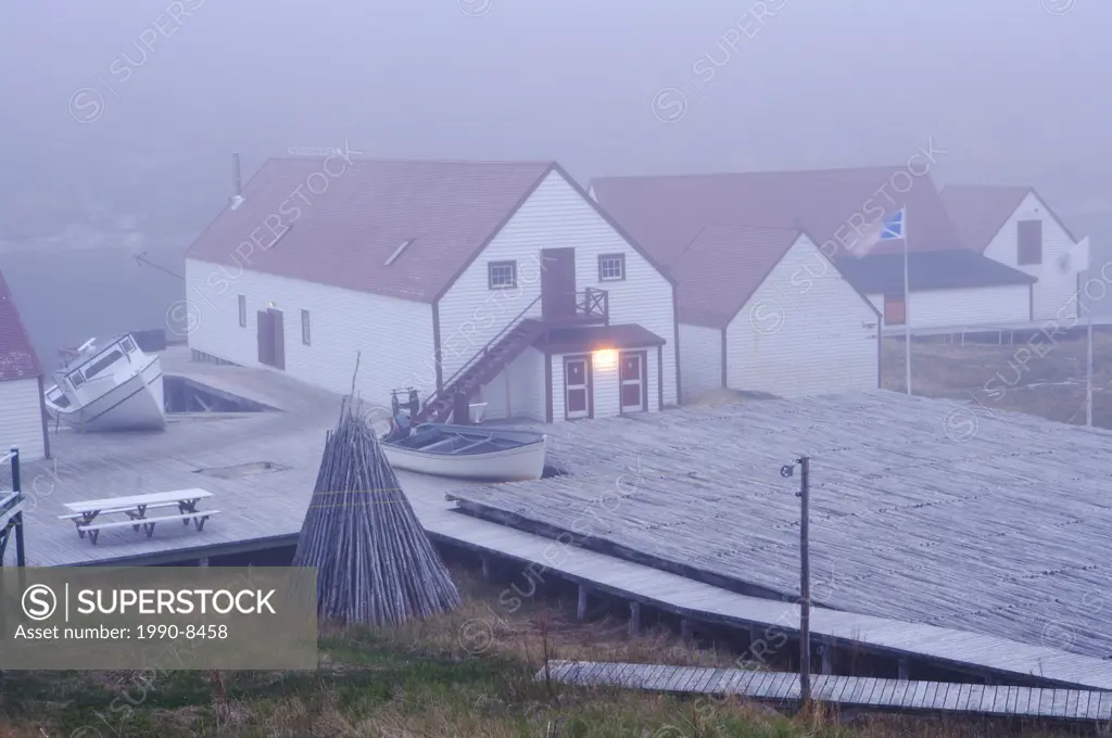 Salmon Store and fish drying flake on a foggy evening in the historic fishing village of Battle Harbour situated on Battle Island at the entrance to t...