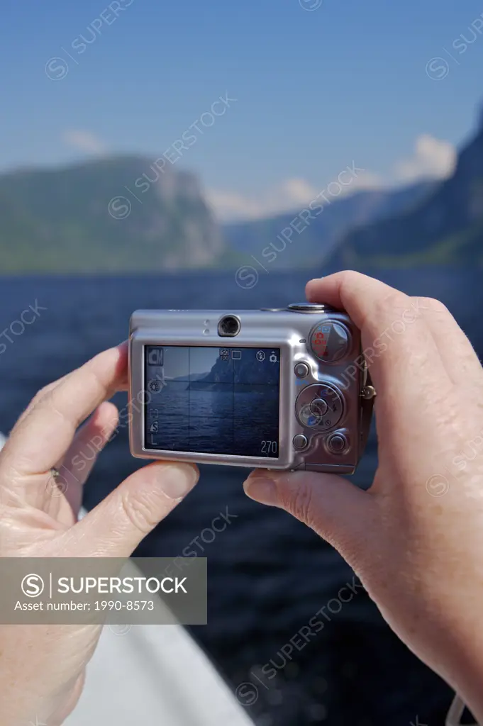 Tourist on a boat tour of Western Brook Pond taking photos, Gros Morne National Park, UNESCO World Heritage Site, Viking Trail, Great Northern Peninsu...
