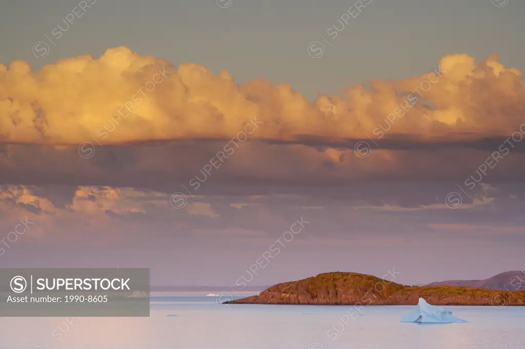 Iceberg and coastal scenery seen from the viewpoint of the Ocean View Trail during sunset in the town of Fleur de Lys, Dorset Trail, Baie Verte Penins...