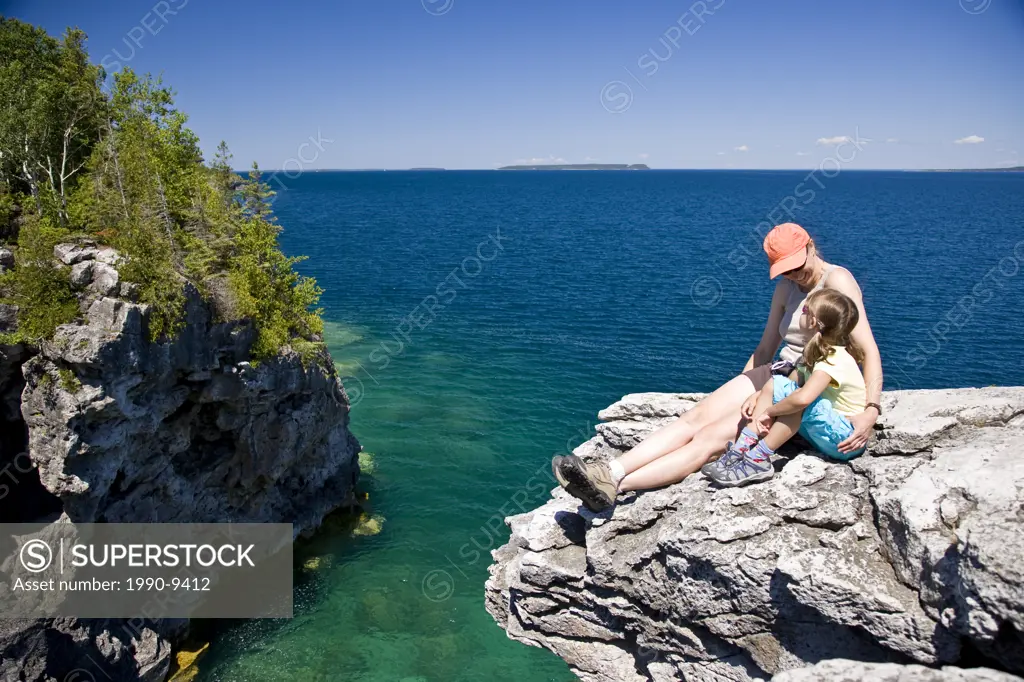 Young mother and daughter enjoy view at The Grotto along Bruce Trail, Bruce Penninsula National Park, near Tobermory, Ontario, Canada.