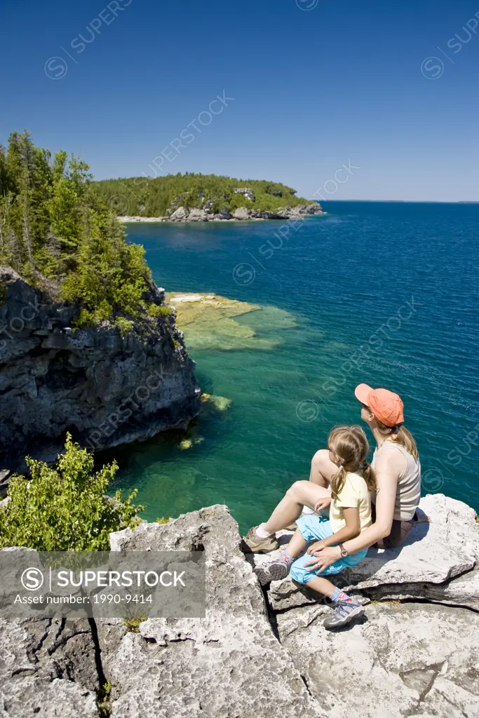 Young mother and daughter enjoy view at The Grotto along Bruce Trail, Bruce Penninsula National Park, near Tobermory, Ontario, Canada.